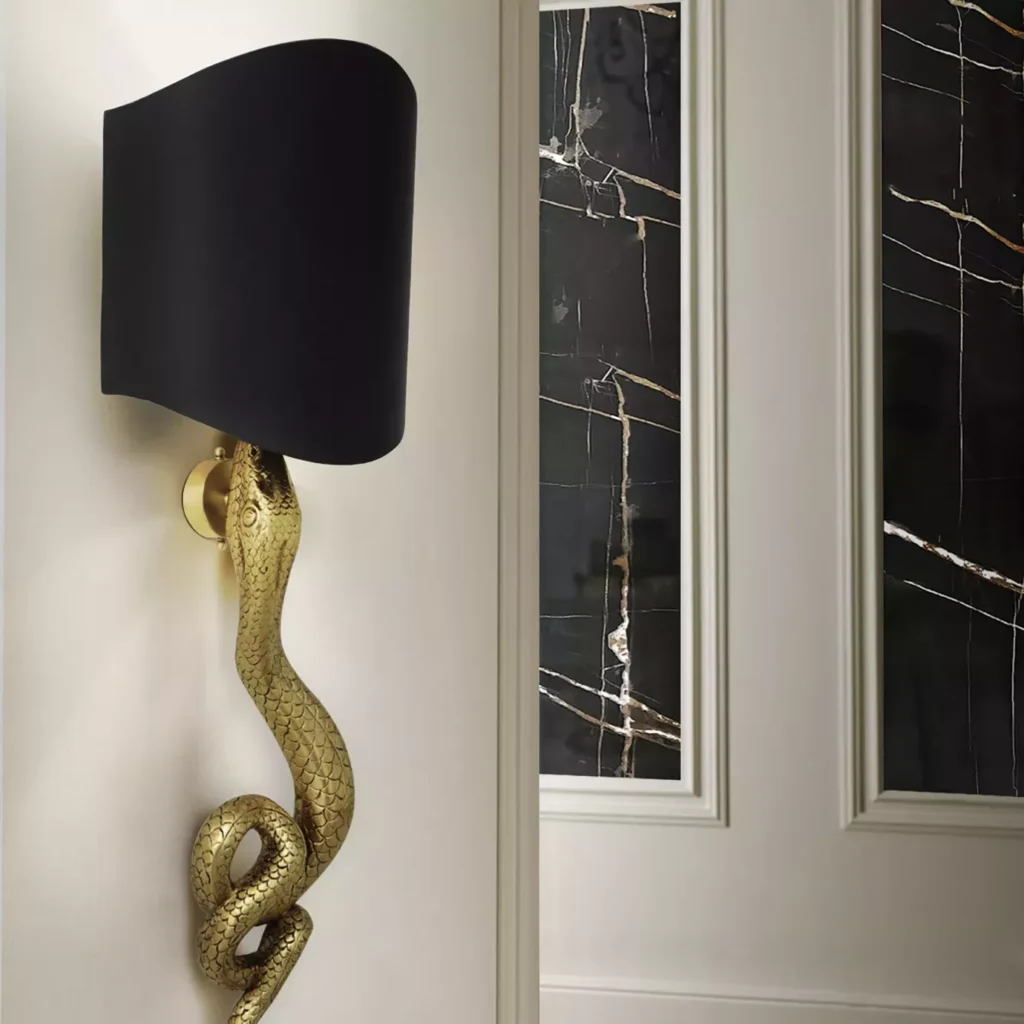 On the wall, a golden serpent-resembling sconce.