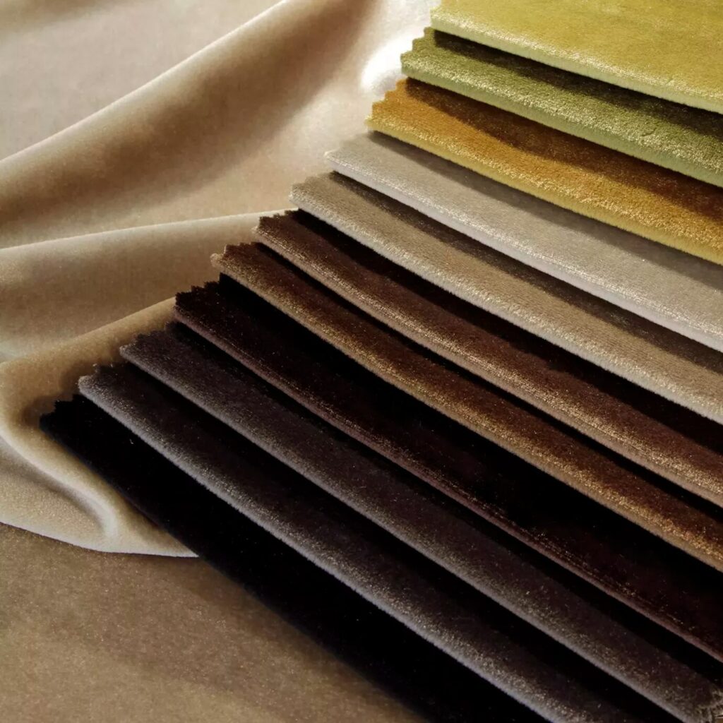 A luxurious selection of textiles and fabrics from KOKET, featuring a variety of rich textures, vibrant colors, and intricate patterns designed to enhance the elegance and style of any furniture piece.