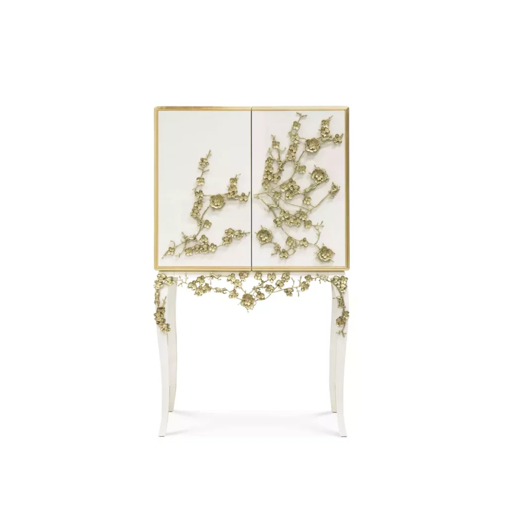 Spellbound Lacquer Bar Cabinet: A white bar cabinet with delicate golden flower-motifs adorning the front. 