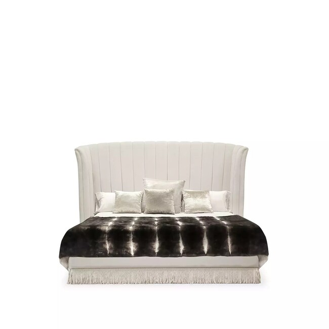 Sevilliana Bed has a graceful, slightly curved frame in cream tones.