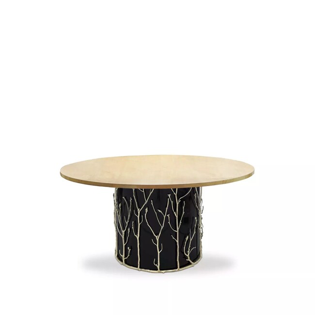 Featuring a wooden tabletop, the Enchanted Dining Table has a black structure adorned with intricate aged brass details, resembling branches.