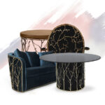 Moodboard of different pieces that integrate the Enchanted Collection: A navy blue sofa, a vlack dining table, a black chair and a brown side table. All of these pieces are adorned with aged brass elements that resemble branches.