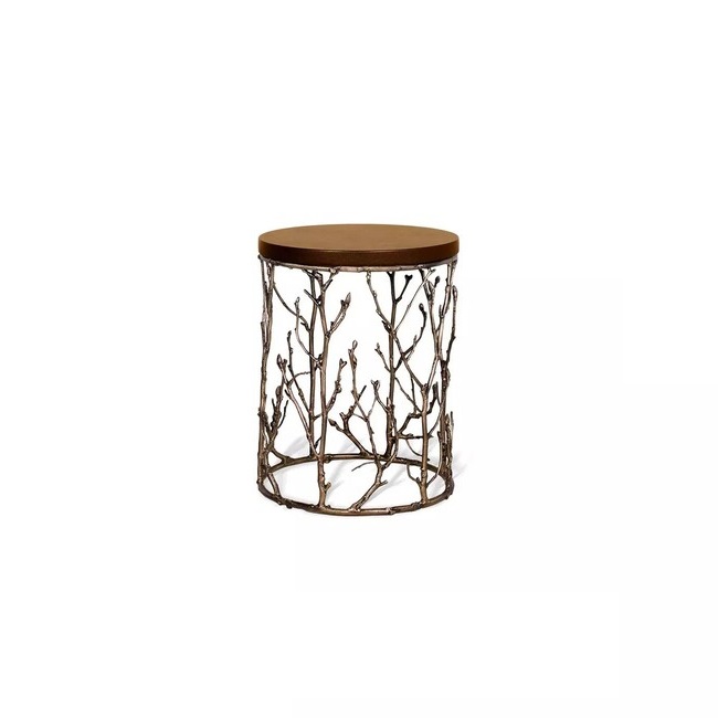 Featuring a leather tabletop, the Enchanted Synthetic Leather Side Table has a structure adorned with intricate aged brass details, resembling branches.