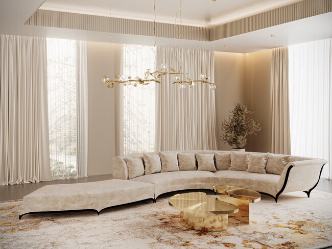 A neutral colored room with a large Heavenly Sofa in the center. The room also features some golden details such as the chandelier above it and the Myth Coffee Table next to the sofa.