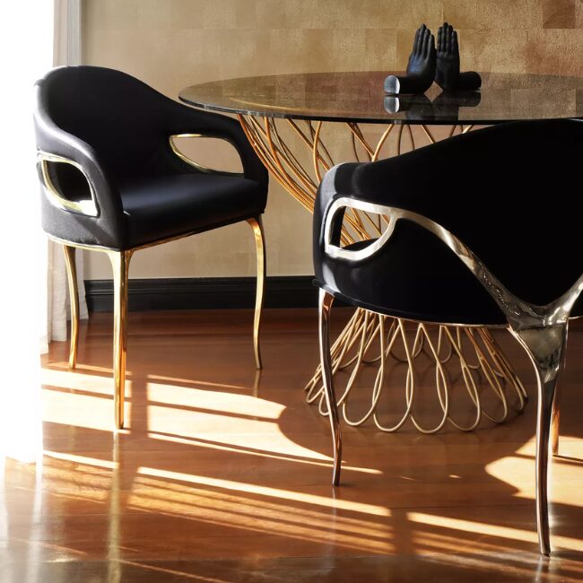 Display of Chandra Dining Chair, demonstrating its distinctive feature of only having 3 legs, contrasting with the elegant black upholstery. 