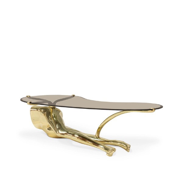 Tabu Polished Brass Coffee Table has an alluring golden base, resembling the legs of a woman, combining with the curvy smoked glass tabletop. 