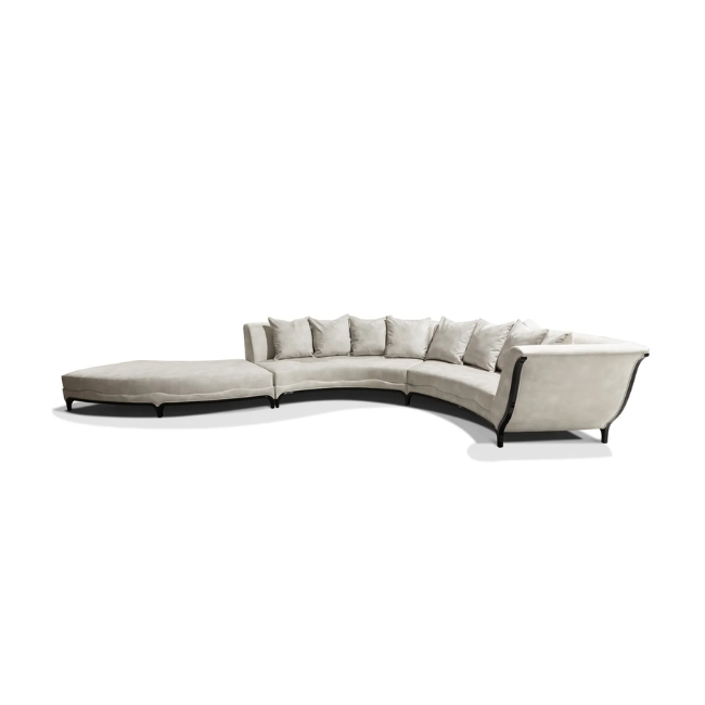 A large curved sofa, the Heavenly Sofa has cream tones and small black details.