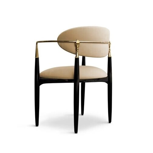 Nahéma Chair: contrasting with its black structure, the chair has velvet upholstery in cream tones, with luxurious golden details.