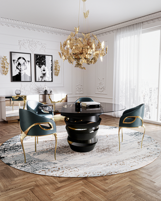 KOKET Intuition round swirling black and gold dining table metal with brass butterfly chandelier and sconces and the iconic chandra luxury feminine dining chairs
