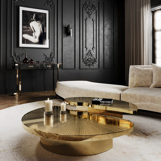 Elegant brass coffee table with sunburst-etched top and sculptural form.