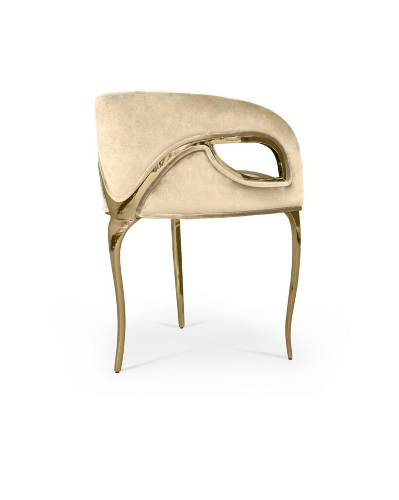 Elegant upholstered chair with gold accents by KOKET, perfect for boutique hotel lobbies