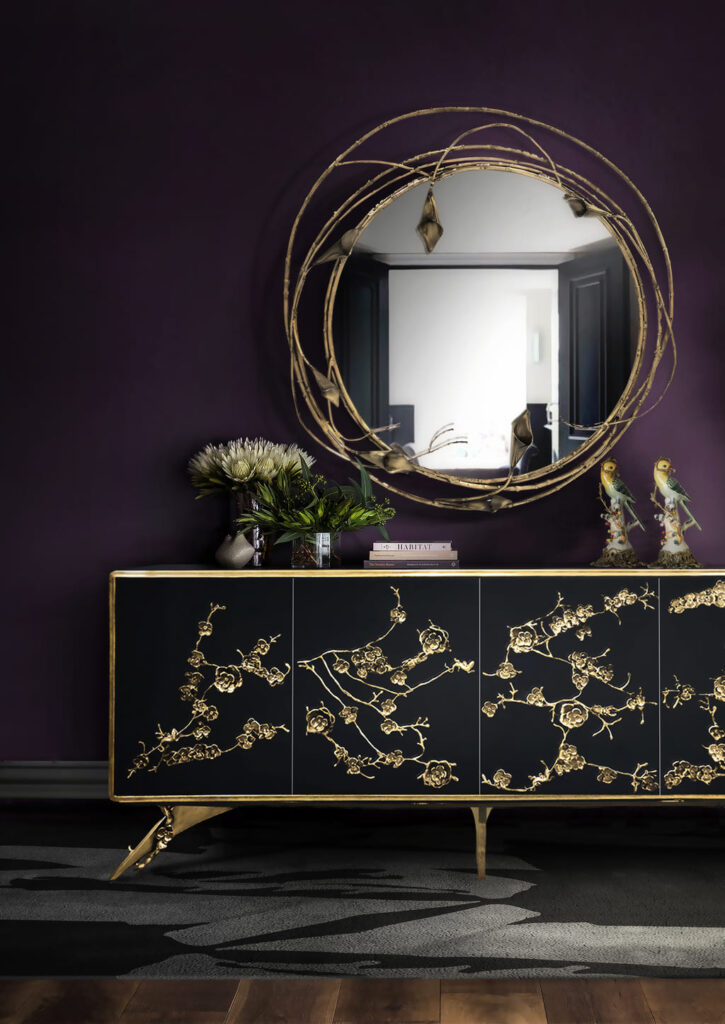 Spellbound floral lace black lacquer cabinet and stella tulip mirror in brass against a mauve wall - design miami 2025