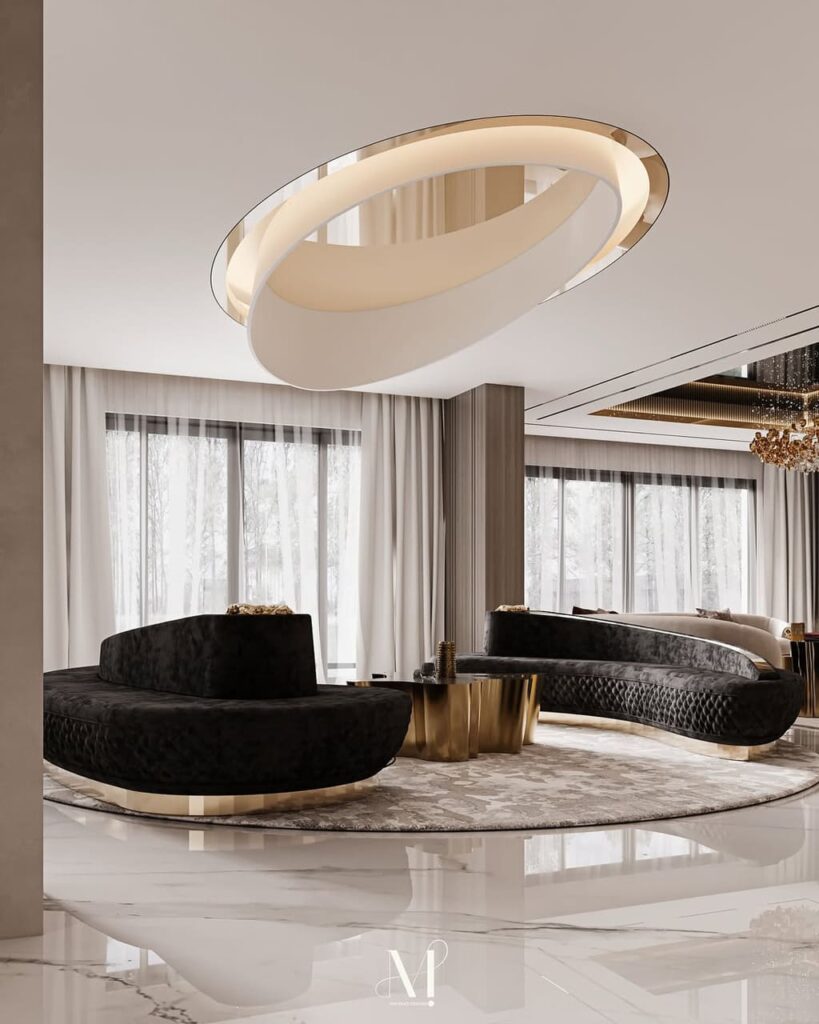 gold coffee table and curved Reptilian sofas by KOKET, Dubai living room design